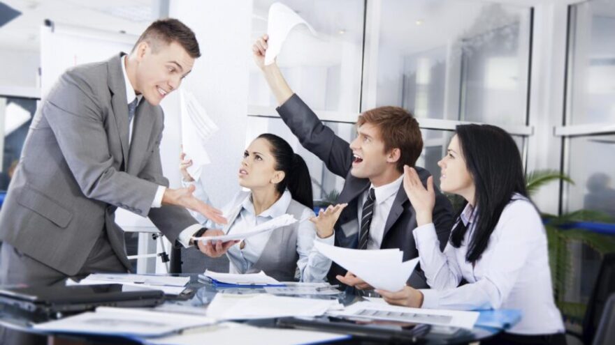 Business people in a conflict at work, arguing with negative emotions and negative mental health implications.