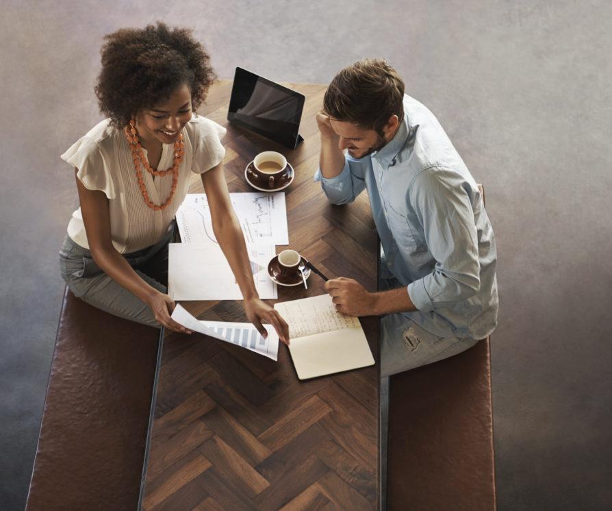 Female and male employees have a meeting regarding business support staff hiring