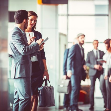 Two business colleagues talking in the entrance to finance offices