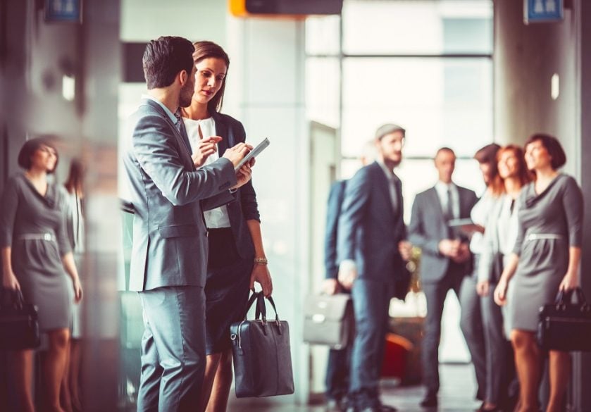 Two business colleagues talking in the entrance to finance offices