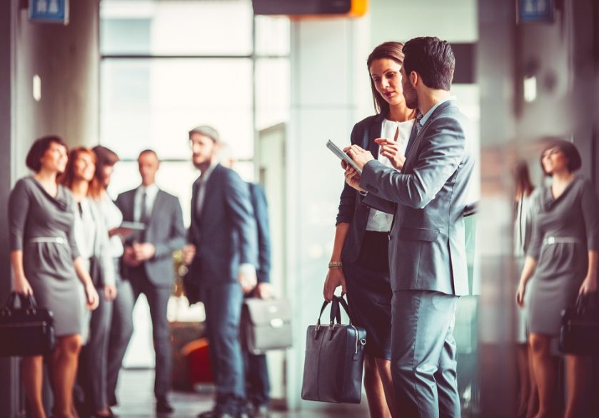 Two business colleagues talking in the entrance to finance offices