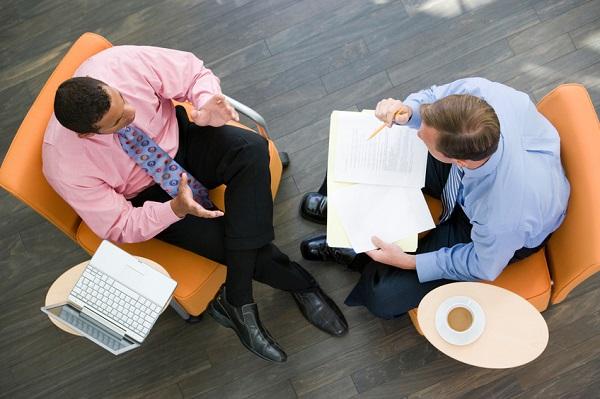 Two men having a registration for a recruitment agency.