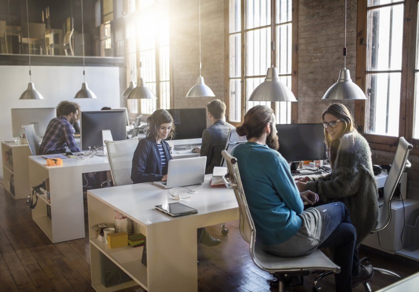 Creative colleagues talking in a modern office.