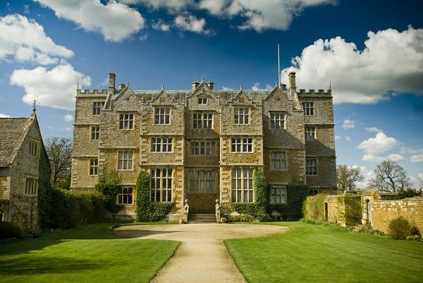 An old, grand mansion with a manicured garden, where housekeepers work for their principal.