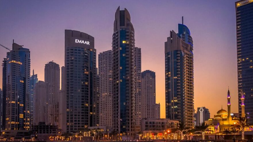 Dubai cityscape with sky scrapers and water in the foreground