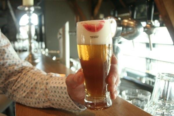 A photo of a lipstick stained glass of beer