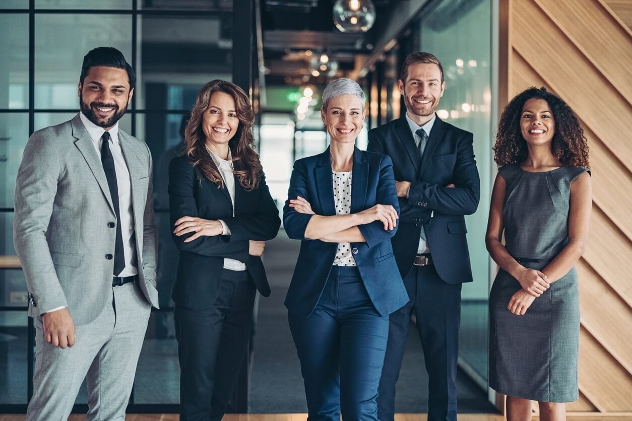 Staff lined up in an office looking welcoming