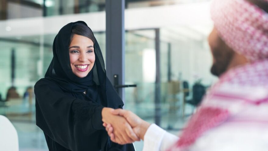 Woman and man shaking hands