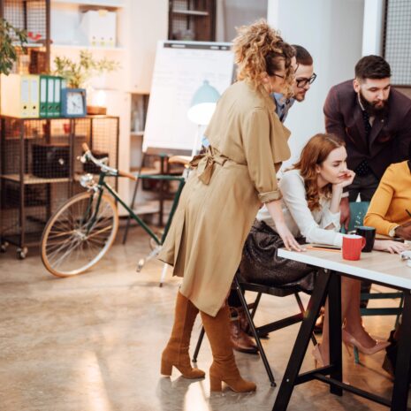 Group of people surrounding a computer