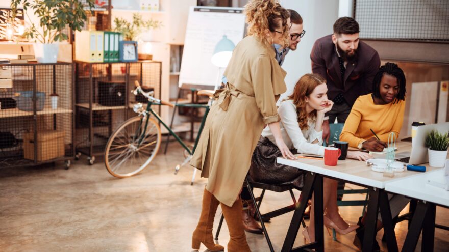 Group of people surrounding a computer