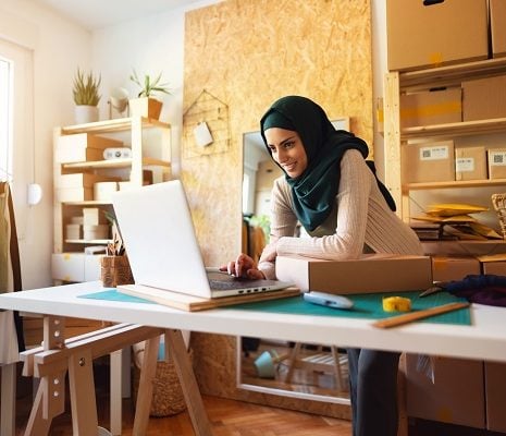 A small business owner packaging an order for a customer