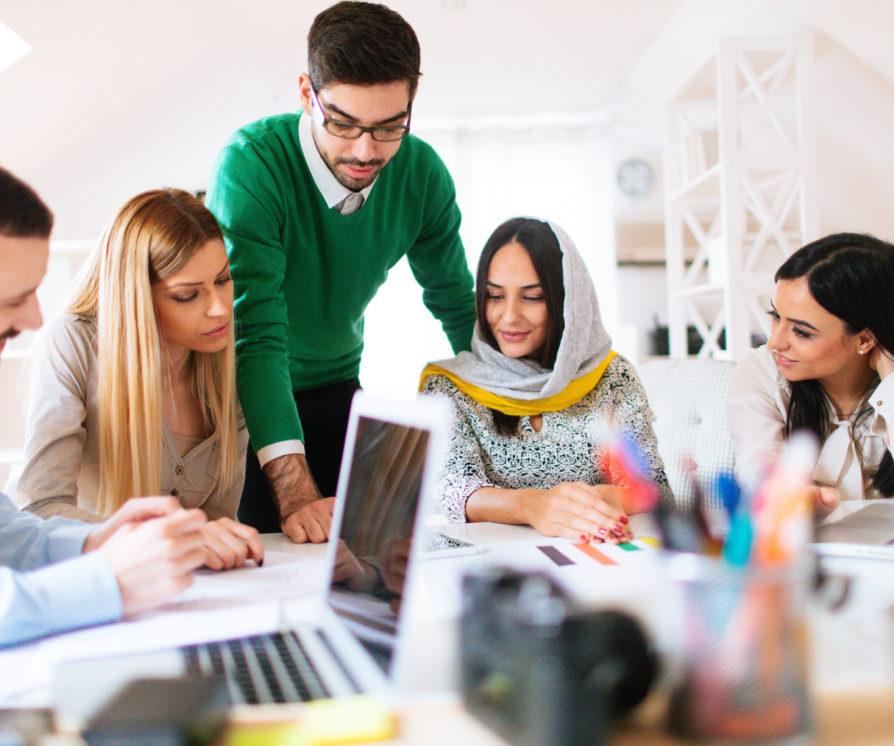 Group of people sitting around in an office talking in legal hiring firm in dubai