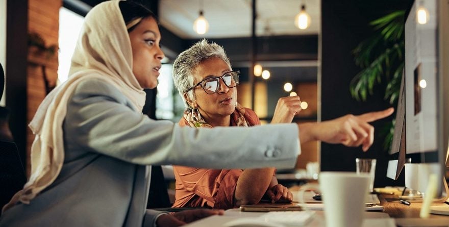 Two Dubai businesswomen working together at a computer