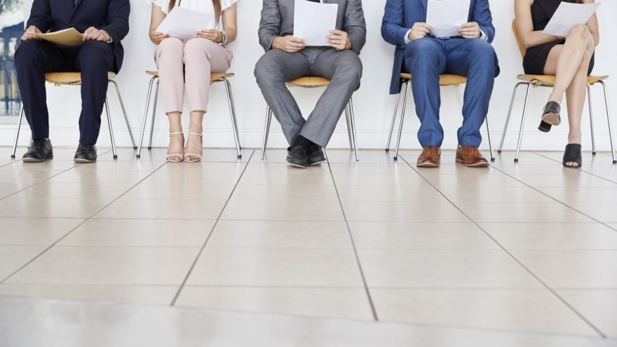 Five candidates waiting for job interviews, front view, crop