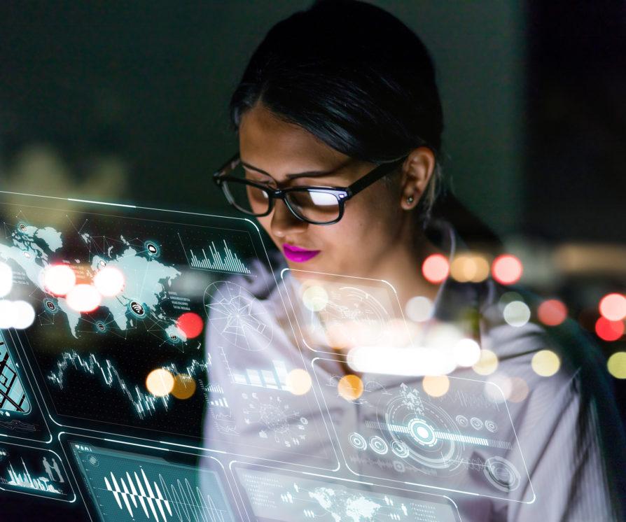 woman engineer looking at various information in screen of futuristic interface.