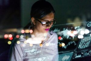 Engineer looking at various information in screen of futuristic interface.