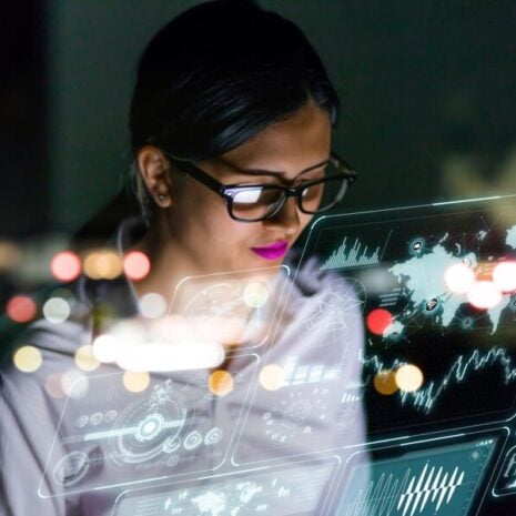 Engineer looking at various information in screen of futuristic interface.