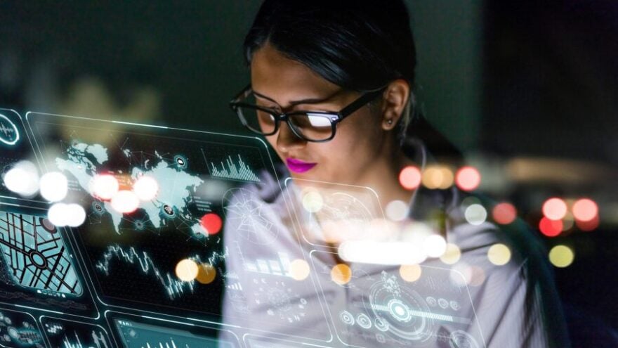 A female engineer is looking at information on an interface, thinking about how technology is affecting the future of work.