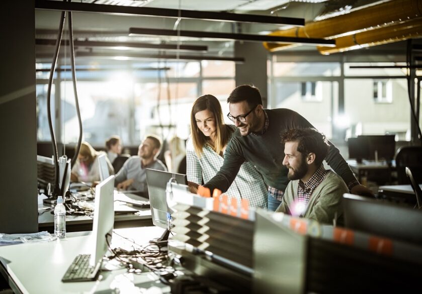 group of developers in front of a computer