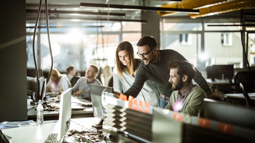 Group of programmers in front of a computer