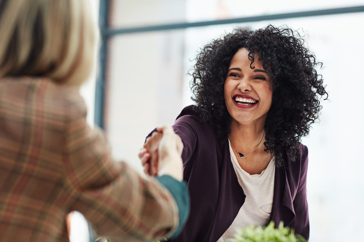 Smiling woman shaking hands with someone
