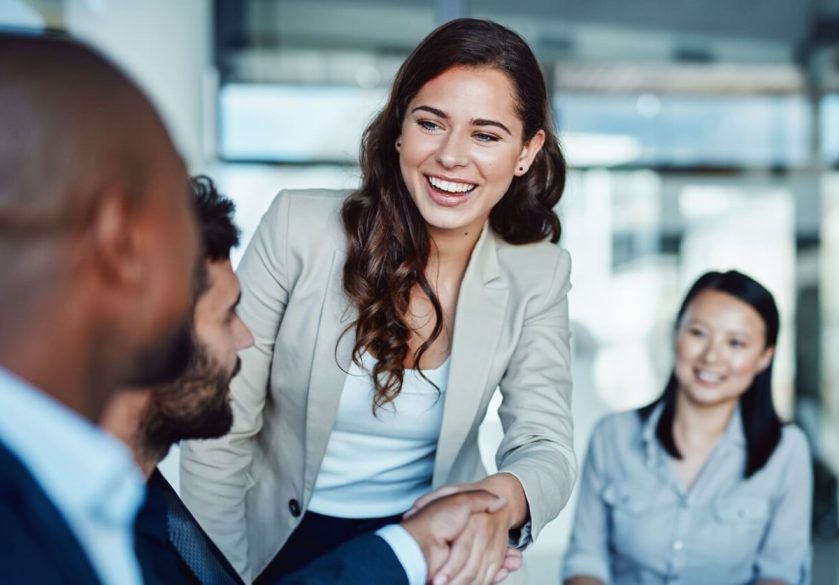 woman shaking hands with interviewers