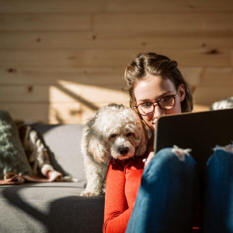 Woman working at home with dog
