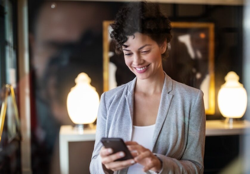 Executive assistant looking at her phone in an office