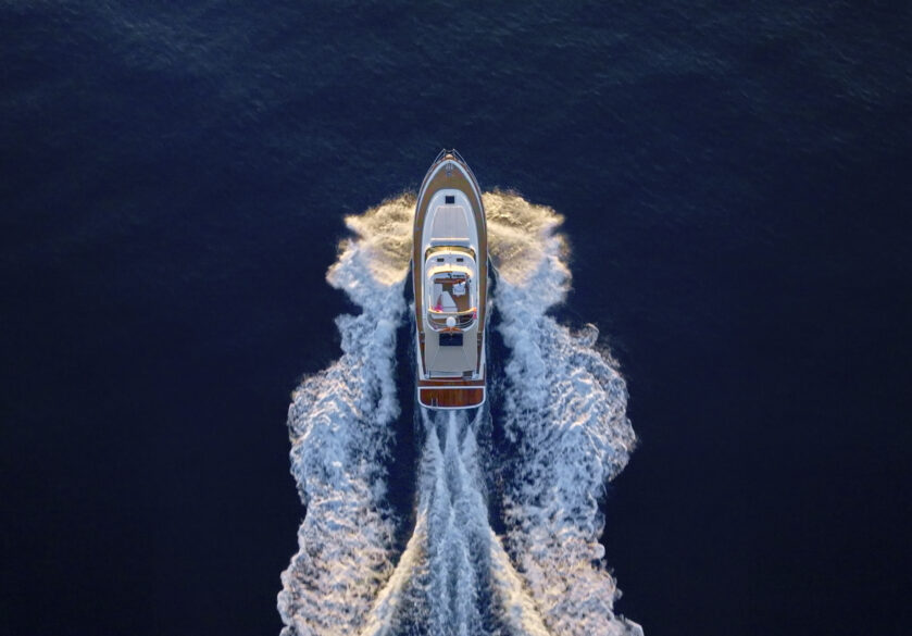 Aerial view of luxury yacht moving fast at Adriatic sea during sunny day.