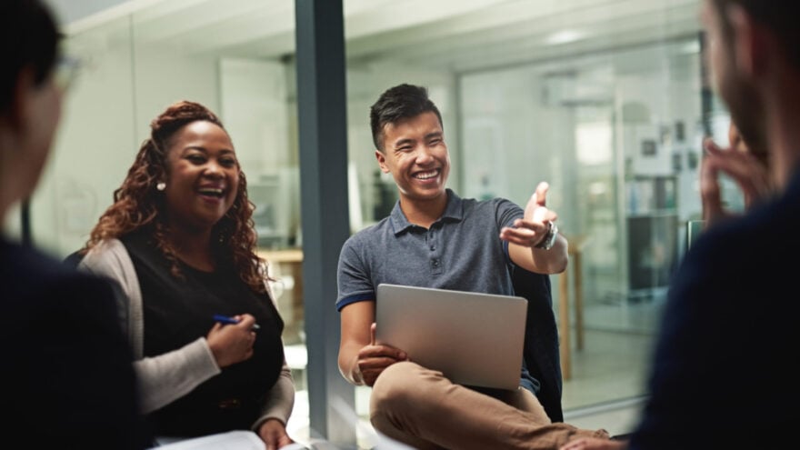 Shot of a group of businesspeople sitting in a circle while having a meeting