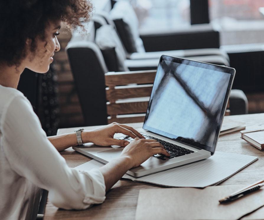 A photo of a PA working on her laptop