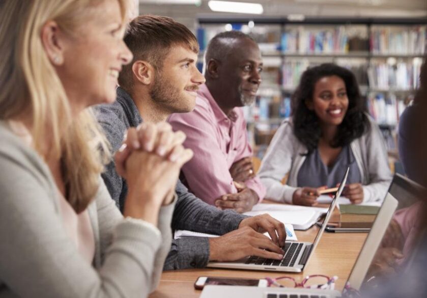 Group Of Mature College Students Collaborating On Project