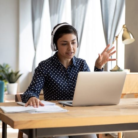 A woman taking a video call on a laptop
