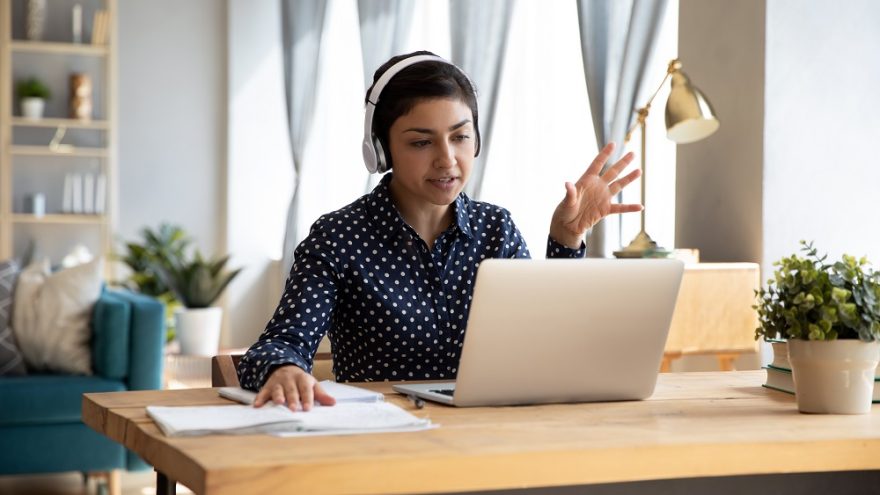 A woman taking a video call on a laptop