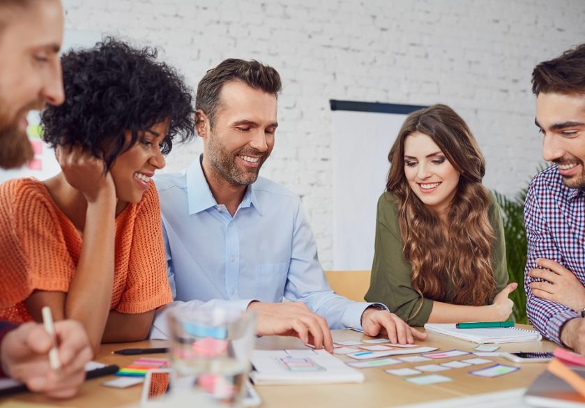 Smiling colleagues working together at an office desk