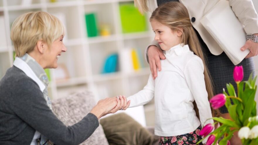 A UHNW nanny meeting the child of her principal in a glamorous mansion.
