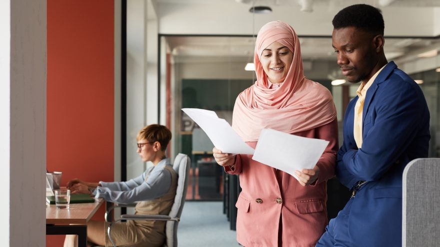 Two Ethnic Business People in Office