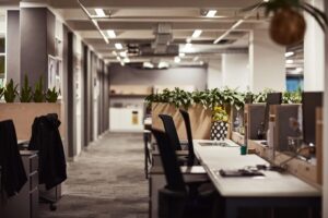 A well-lit, modern and open plan office with a communal space, demonstrative better office design.