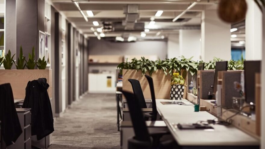 A well-lit, modern and open plan office with a communal space, demonstrative better office design.