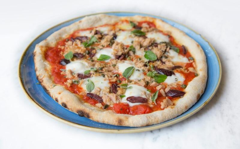 A pizza from Piccolino Heddon St with mozzerella, basil, olives and nuts