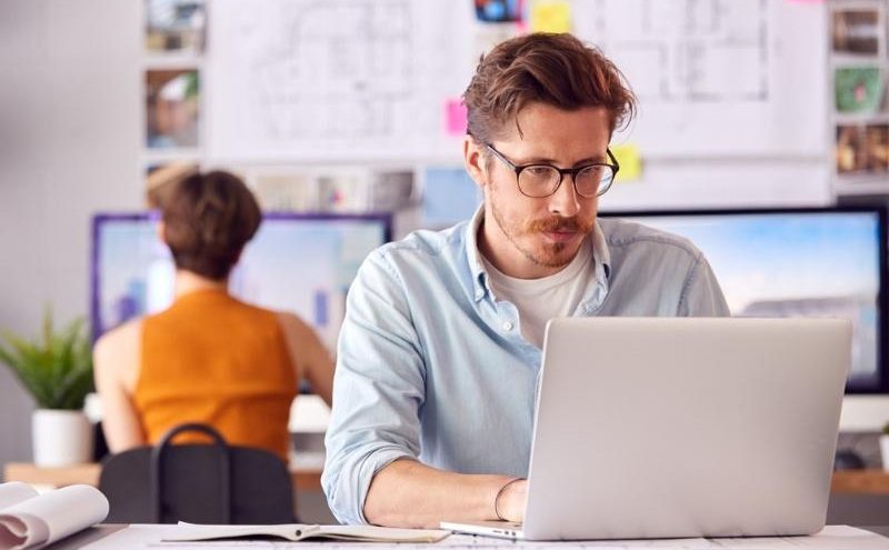 Man in office working on laptop