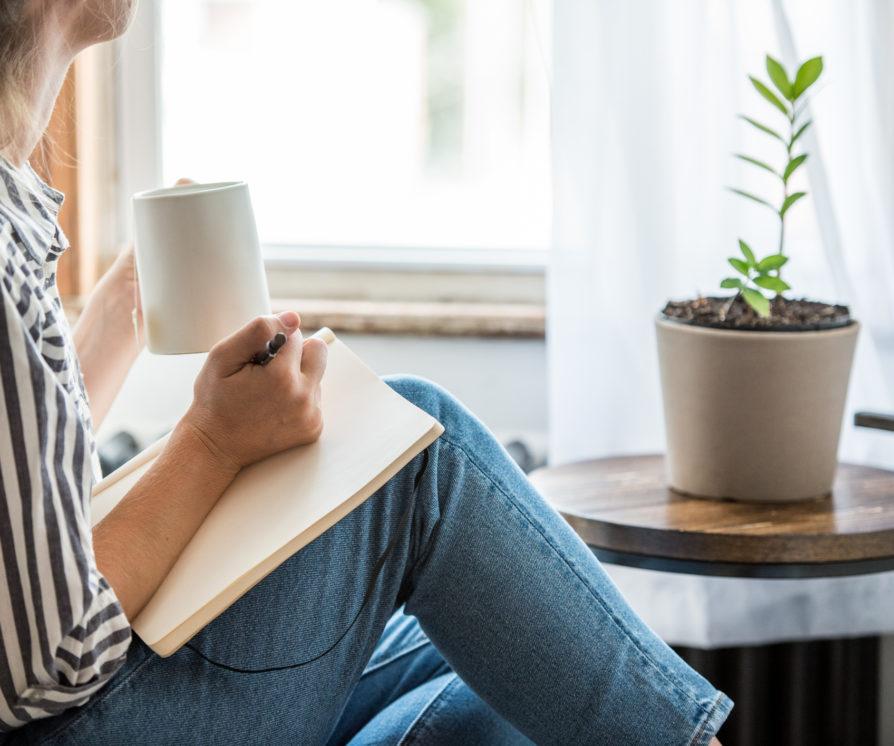 EA takes a break from working at home with a notebook and coffee