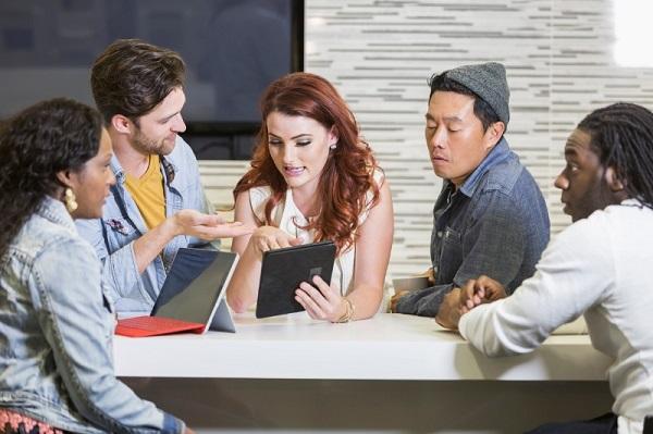The talent pool at a company in an informal meeting, using papers and iPads.