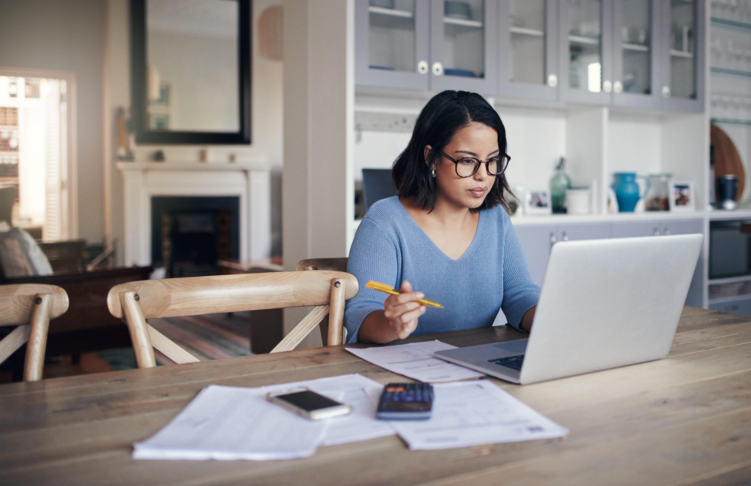 Shot of a young woman using a laptop while working from home