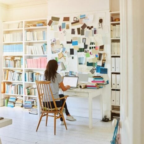 Rear view of a Virtual Assistant in home office and working on laptop