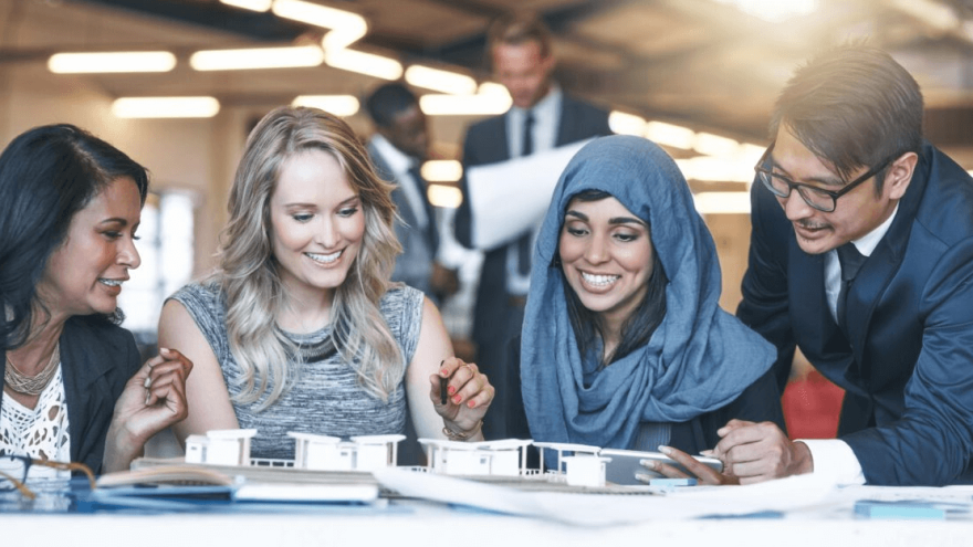 Diverse team in Dubai office laughing